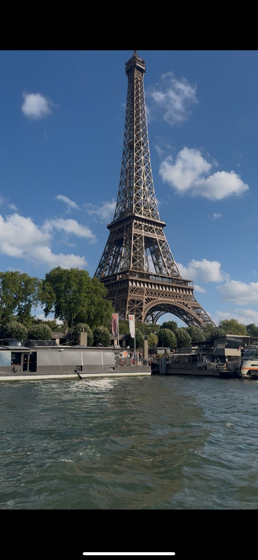 View of the Eiffel Tower from the Seine river on a sunny day in Paris, France — photo by Abdullah Al-Marweai