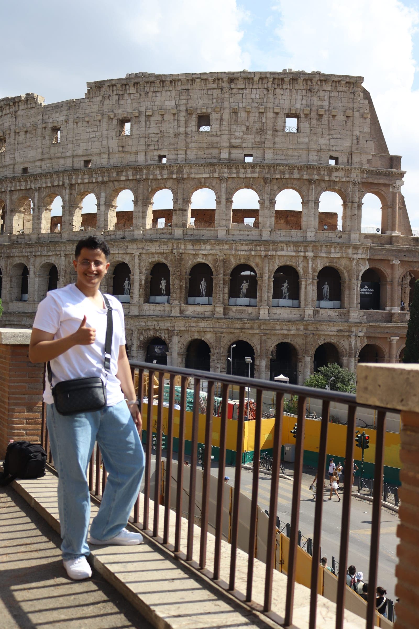 Abdullah Al-Marweai giving a thumbs up in front of the Colosseum in Rome, Italy